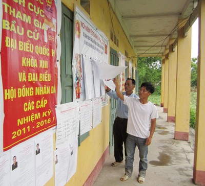 Người dân thôn đảo Tân Lập tranh thủ xem danh sách cử tri và tiểu sử ứng cử viên